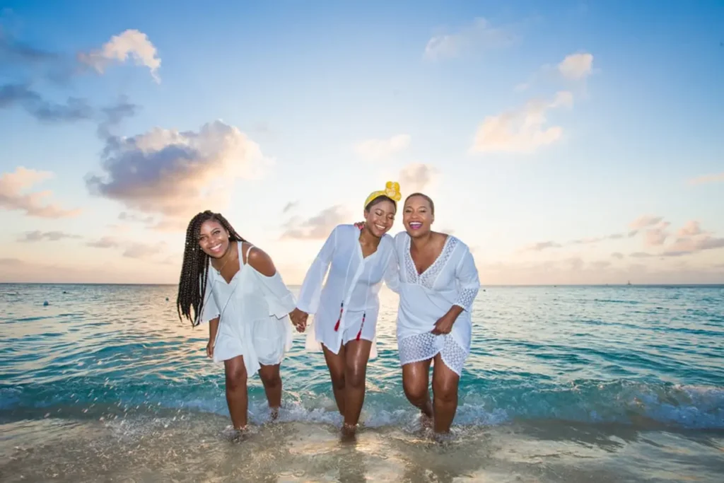 3 women smileing at beach
