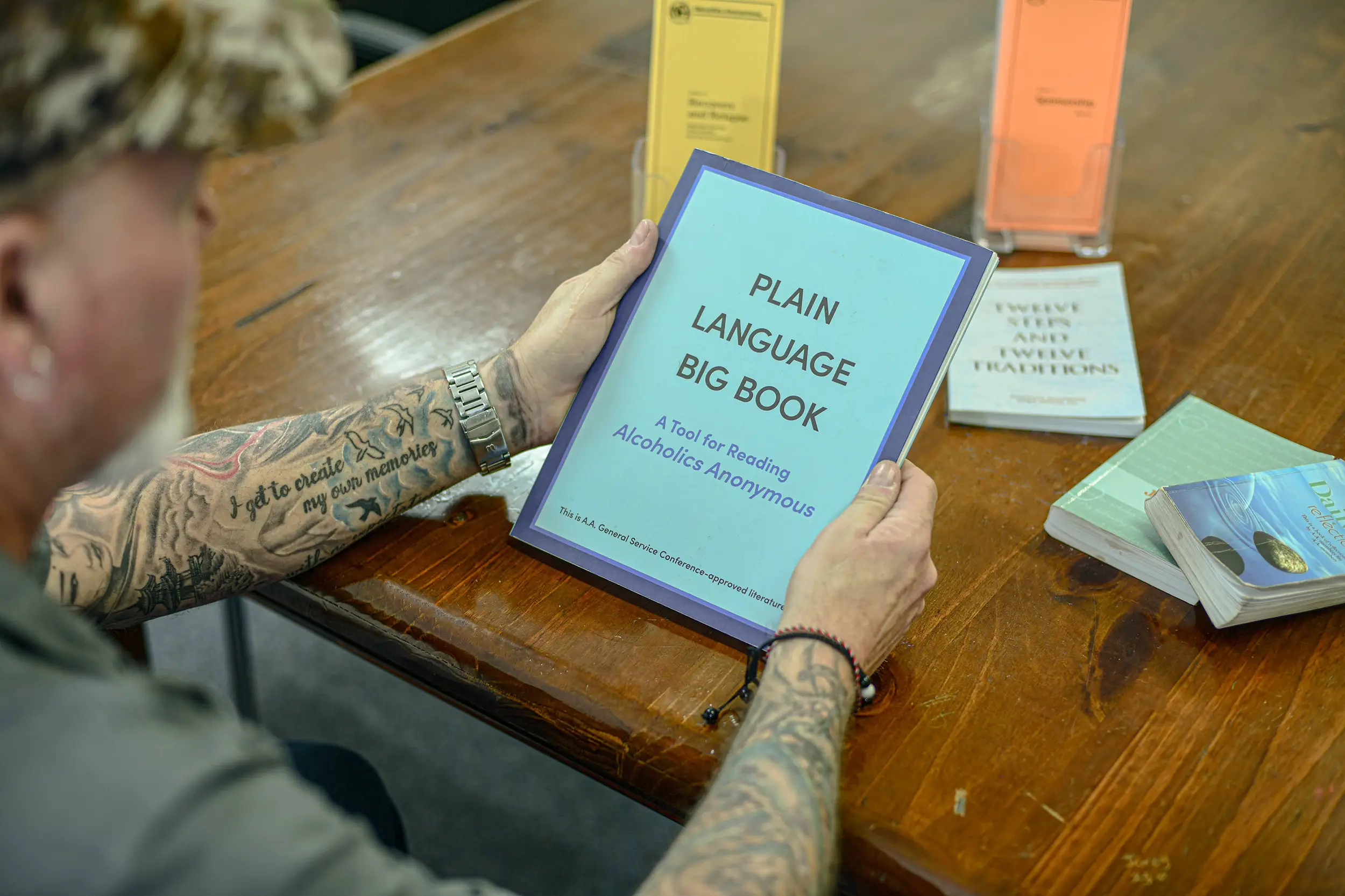 man holding a guid book